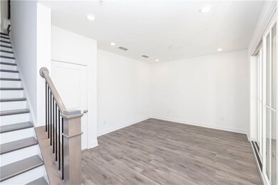 First floor entrance into home from garage and flex/media space with large slider doors to access covered terrace.