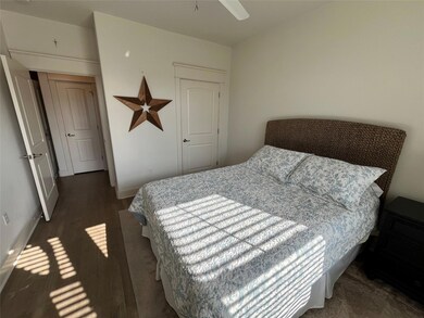 Bedroom with wood finished floors and baseboards