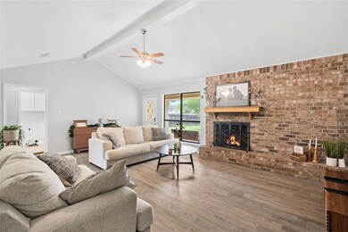 Living room featuring a fireplace, vaulted ceiling