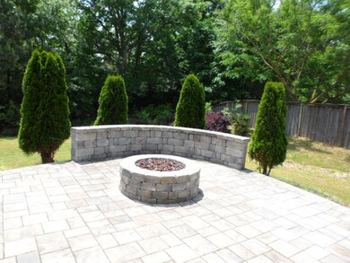 View of patio / terrace with an outdoor fire pit and fence