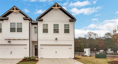 View of front of property with board and batten siding, a garage, and concrete driveway