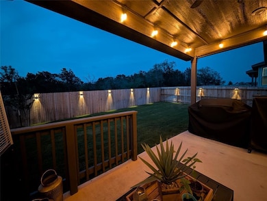 Fenced backyard with a patio area
