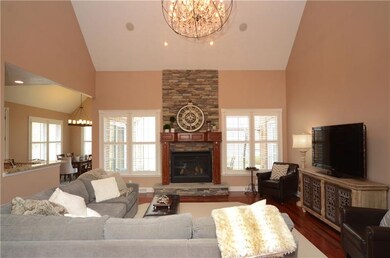 Two Story Family Room Features stacked stone gas f