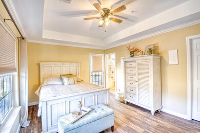 Bedroom featuring a raised ceiling, connected bath