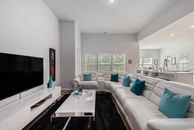Living area with recessed lighting, wood finished floors, and baseboards