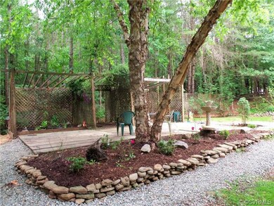 Gorgeous landscaping in rear yard with plant arbor