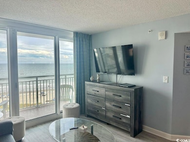 Living room featuring a textured ceiling and wood finished floors