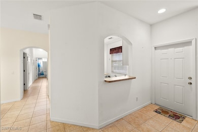 Entrance foyer with light tile patterned floors