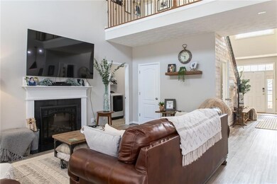 Living room with high vaulted ceiling, hardwood / 
