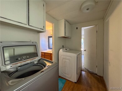 Laundry room with cabinets, washer and clothes dry