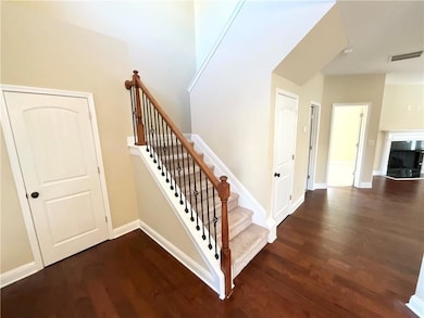 Stairway with wood finished floors and baseboards
