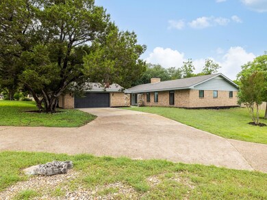 Single story home featuring concrete driveway, a 