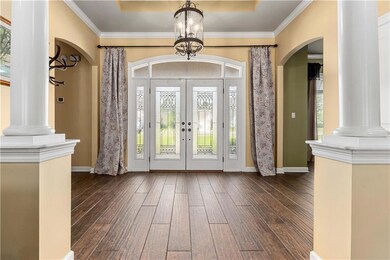 Entryway with arched walkways, decorative columns,