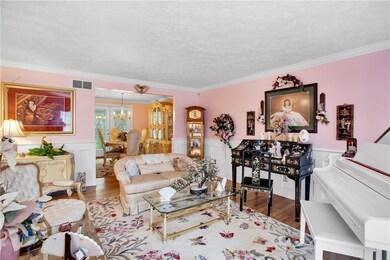 EXQUISITE CROWN MOULDING AND WAINSCOTING ARE THROU