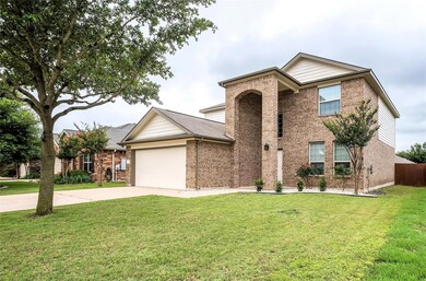 Traditional-style home with brick siding, drivewa