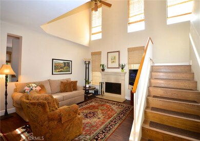 SPACIOUS LIVING ROOM AND A WALL OF WINDOWS OFF OF THE FRONT ENTRY.