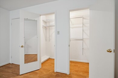 Walk in closet in primary bedroom.