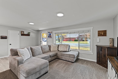 Living area featuring light carpet