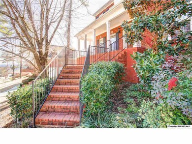 Grand entrance to this home perched on a hill overlooking the area.