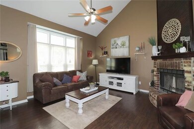 Great room with hardwood floors, fire place and va