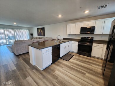 Kitchen featuring black appliances, open floor pla