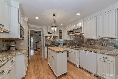 Gourmet kitchen with custom white cabinetry. High 