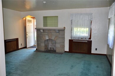 Living room with gas fireplace and recessed radian