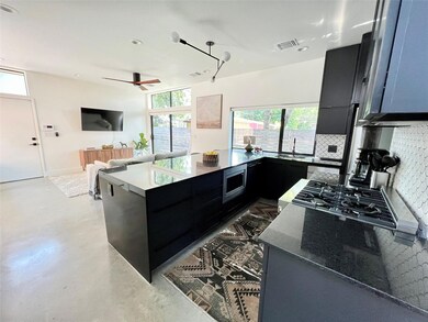 Kitchen with visible vents, a ceiling fan, stainl