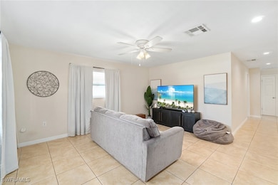 Living room with light tile patterned floors and c