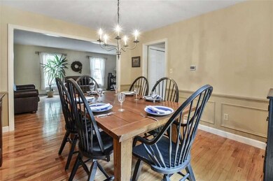 Gleaming hardwood flooring are the perfect compliment to the expansive living and dining rooms with oversized windows and detailed moldings.