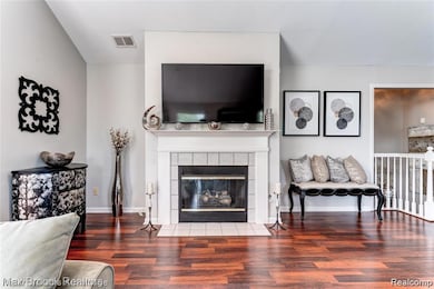 Living room with wood finished floors and a fireplace
