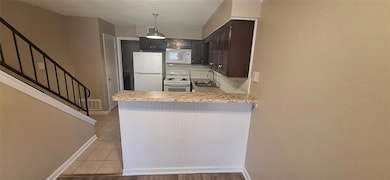 Kitchen featuring light countertops, a peninsula, 