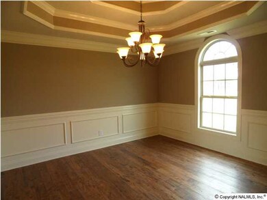 Dining room with double trey, chair rail and shadow box, window with circle top, hand scrapped hard wood flooring.