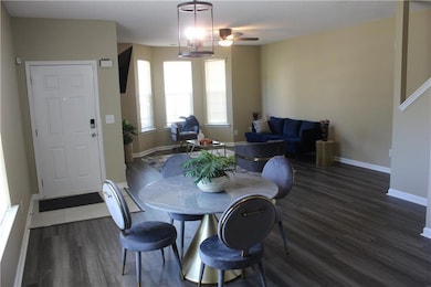 Dining room with dark wood-style flooring and a ceiling fan