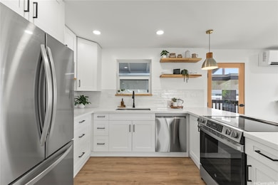 Spacious kitchen with quartz counters & ample cabinetry.