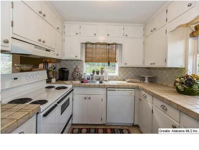 Kitchen with tile countertops, lots of cabinets an
