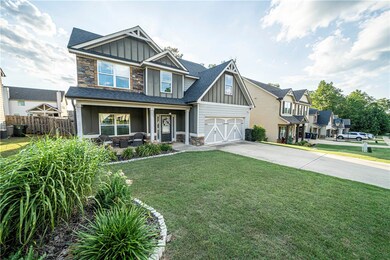 Welcoming front porch & meticulously manicured lan