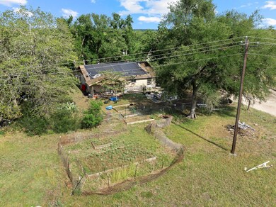 View of grassy yard with a garden and a view of t