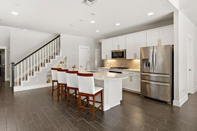 Kitchen featuring an island with sink, a sink, st