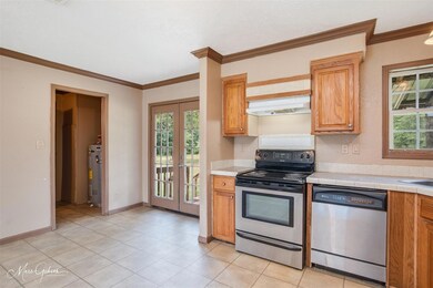 Kitchen with a healthy amount of sunlight, tile co