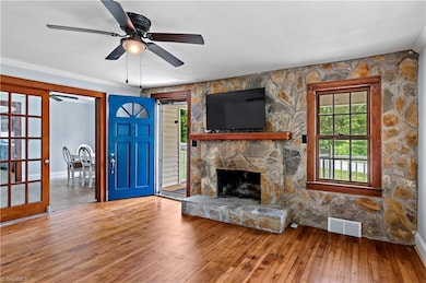 Large Family room with fireplace and original solid hardwood floors.