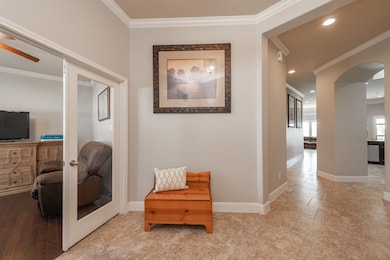 The extended entry guides you past the kitchen into the open family room area.