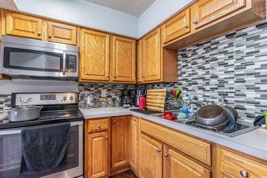 Kitchen with a textured ceiling, sink, stainless s