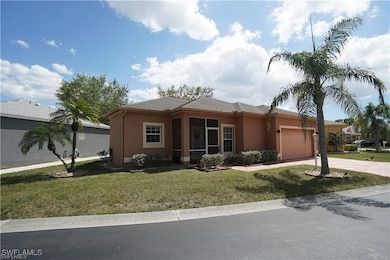 View of front of property with stucco siding, a ga