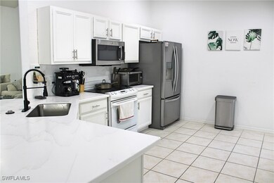 Kitchen featuring light tile patterned floors, whi