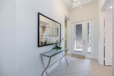 Entryway featuring light tile patterned floors, ba