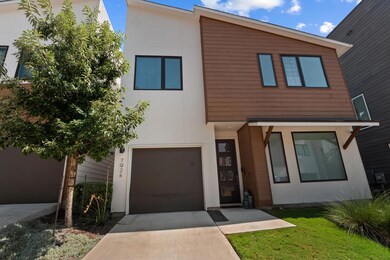 Contemporary house with a garage, concrete driveway, and stucco siding