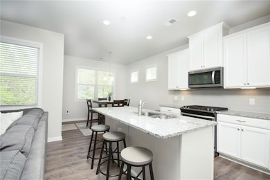 Kitchen with tasteful backsplash, a sink, a kitche