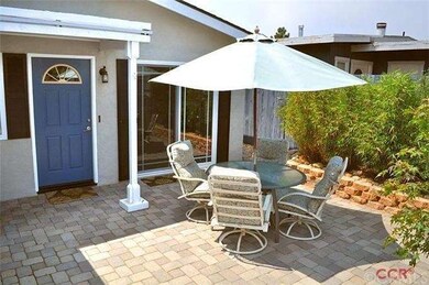Entry courtyard with pavers and privacy fence