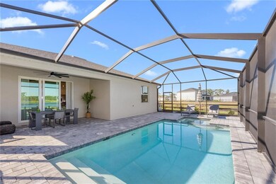 View of swimming pool with a patio, ceiling fan, a pool with connected hot tub, and a lanai